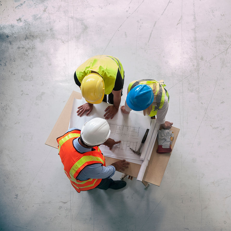 Construction workers planning maintenance